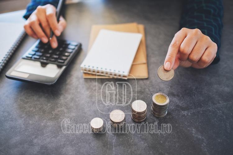 businesswoman holding and stacking coins while calculating money