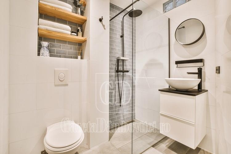 flush,toilet,located,between,sink,and,shower,in,small,tiled