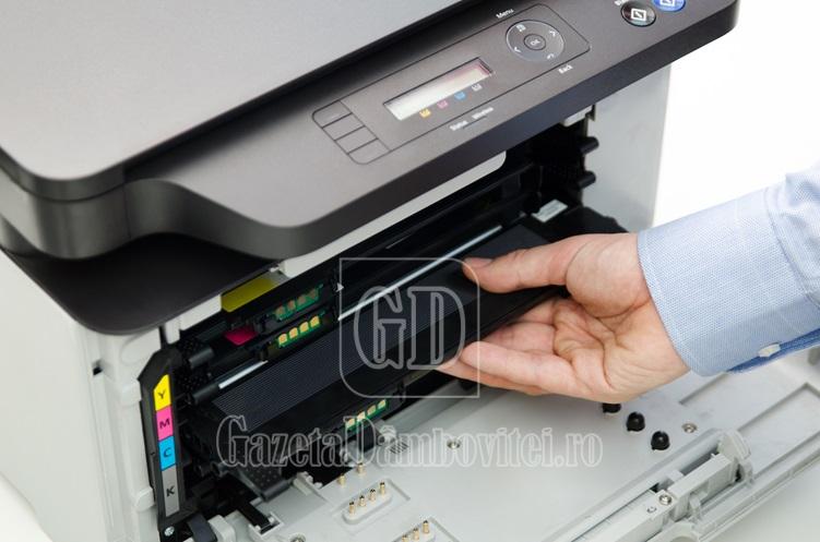 man replacing toner in laser printer