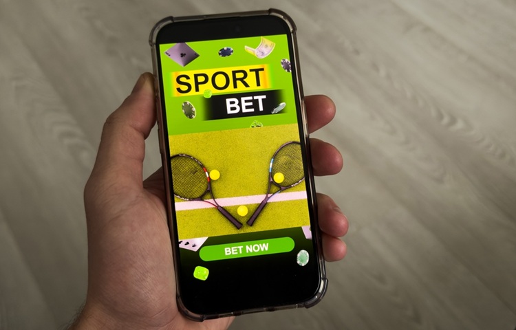 man,betting,on,sports,,holding,smart,phone,with,working,online
