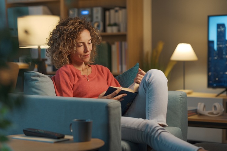 relaxed,happy,woman,resting,on,the,armchair,at,home,in